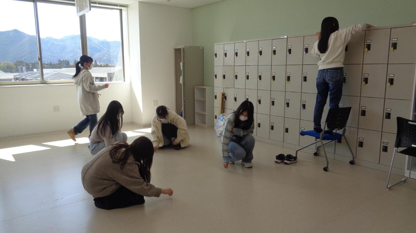 教室の床の汚れを拭いたり、ロッカーの上を拭いたりしている学生たちの写真