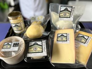 瓶詰めやパウチ、カップに入ったものなど、様々なパッケージに入ったチーズ製品の写真