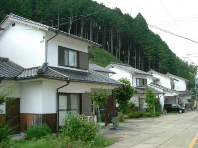 外壁が白色で瓦屋根をした2階建ての建物が並んでいる写真