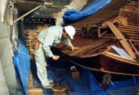 木組みの屋根を修繕する男性の写真